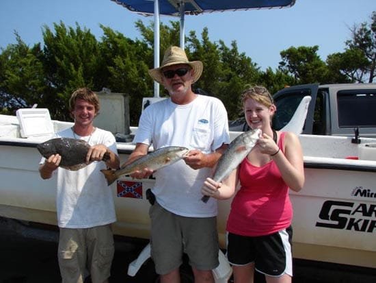 C.J. flounder Rob puppy drum and Kay with a big smile 7-23-2011