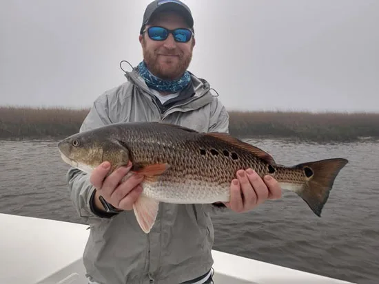 Seahawk Inshore Fishing Charter angler with a fat inshore red drum